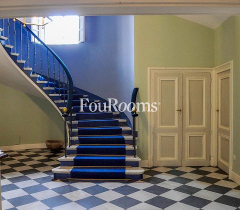 hall con escalera con moqueta azul